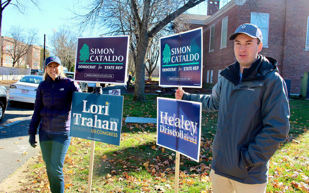 Heather Bout and Kyle Stapelton hold campaign signs outside the polls at the Hunt Recreation Center. Photo by Jennifer Lord Paluzzi