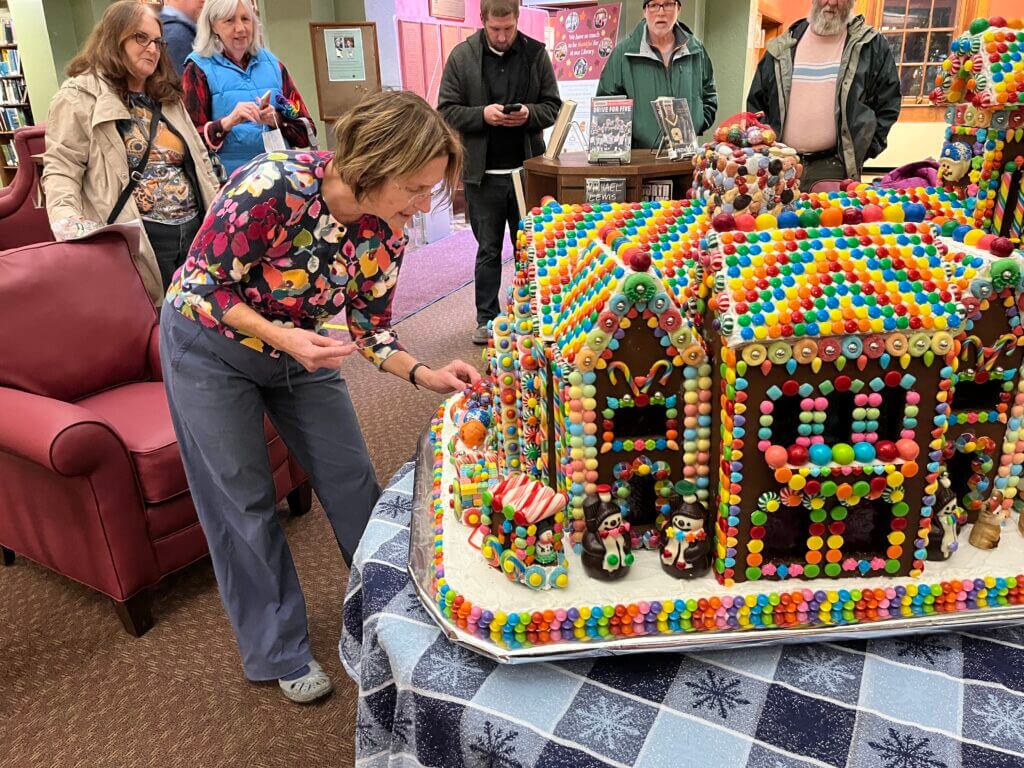 Dr. Andrea Resciniti donated a gingerbread house to the Concord Library for the 28th time recently. The detailed house weighs about 130 pounds and consists of 34 batches of gingerbread, and loads of candies. She started to make it in early November. It will be on display at the library until early January. Photo by Betsy Levinson